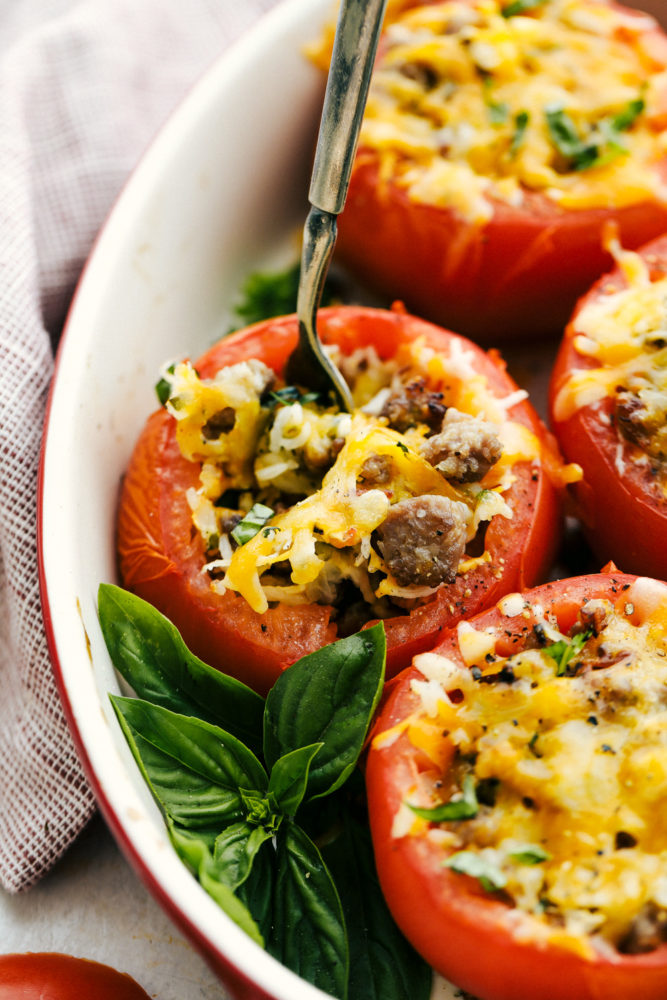 Cheesy Stuffed Tomatoes with Sausage are tomatoes stuffed with a hearty sausage and rice filling and topped with gooey cheese.