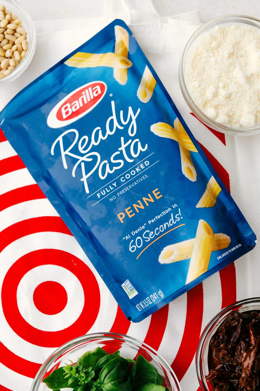 Barilla Ready Pasta laying on its back over top a target bag. 