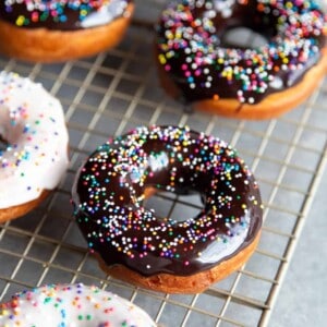 Glazed donuts with sprinkles on a wire rack