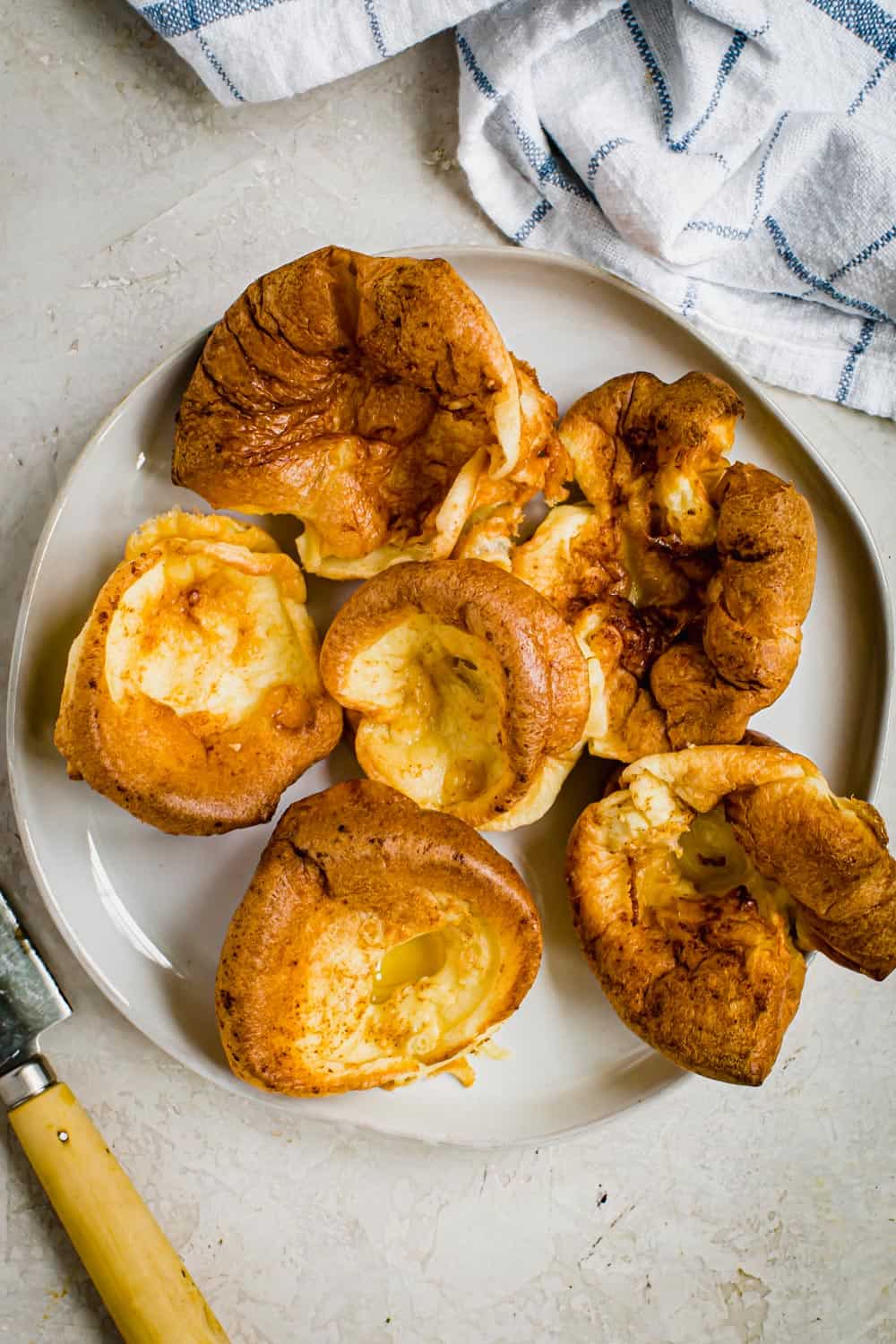 Individual Yorkshire pudding on a white plate.