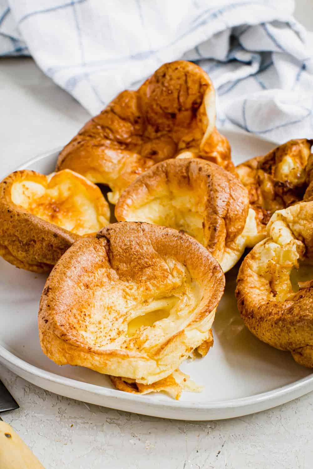 Individual Yorkshire pudding on a white plate.