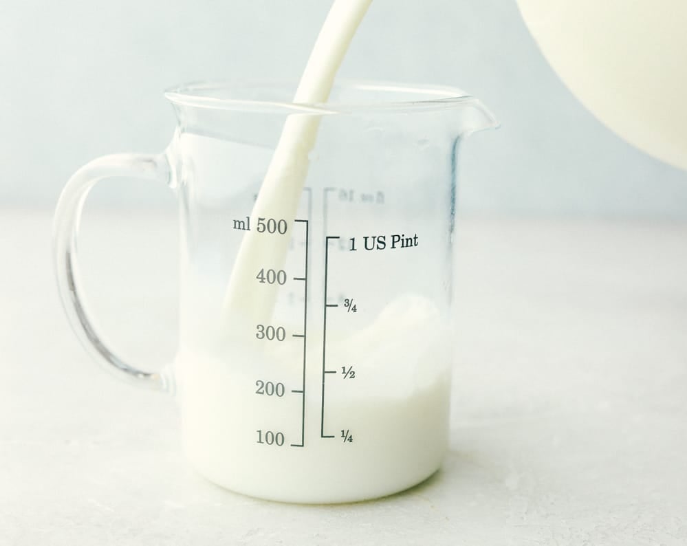 Measuring milk for homemade buttermilk.