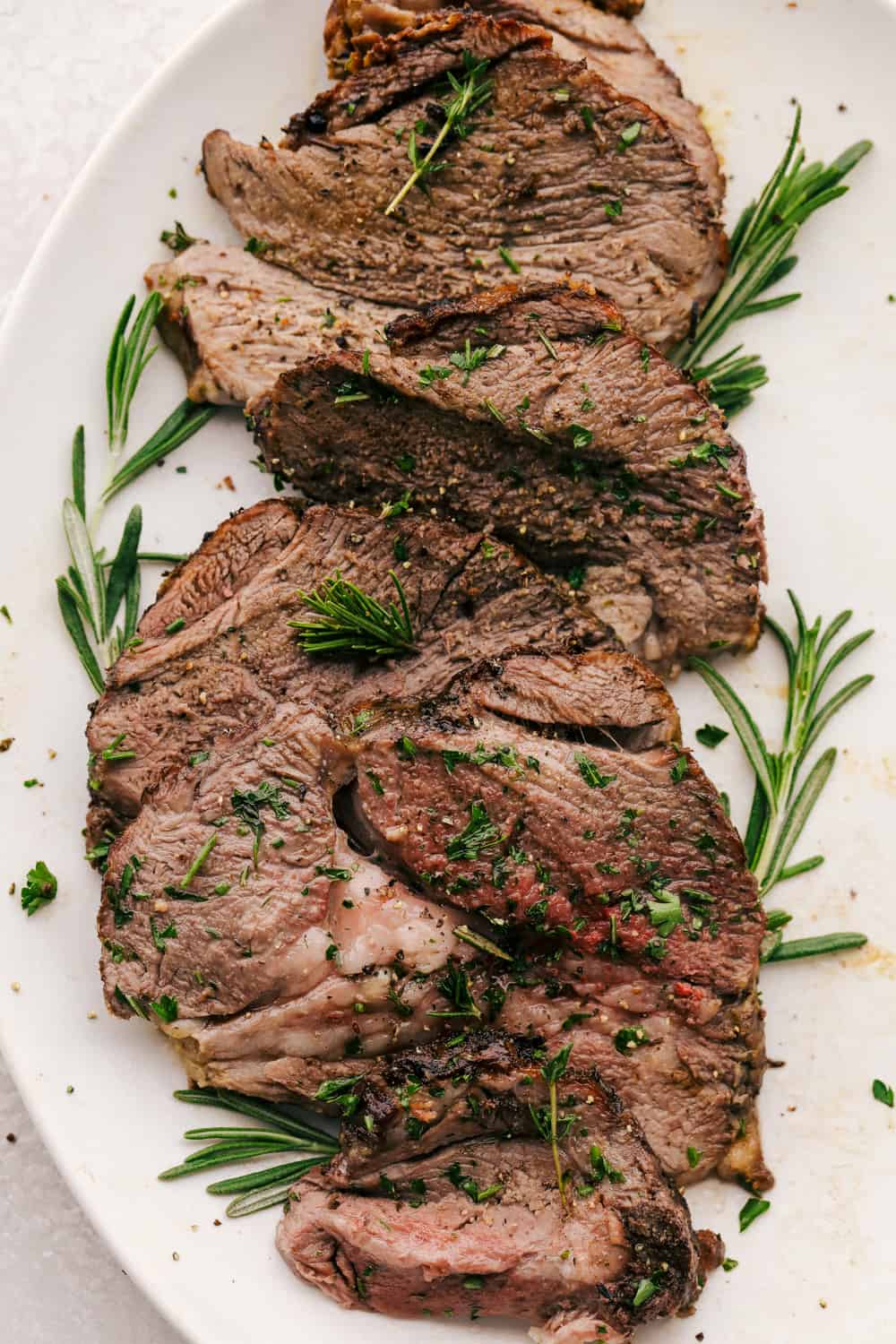 Roasted Garlic Herb Crusted Lamb on a platter.