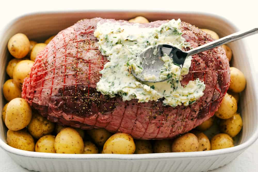 Puting the Garlic Herb Crust on the lamb for roasting.