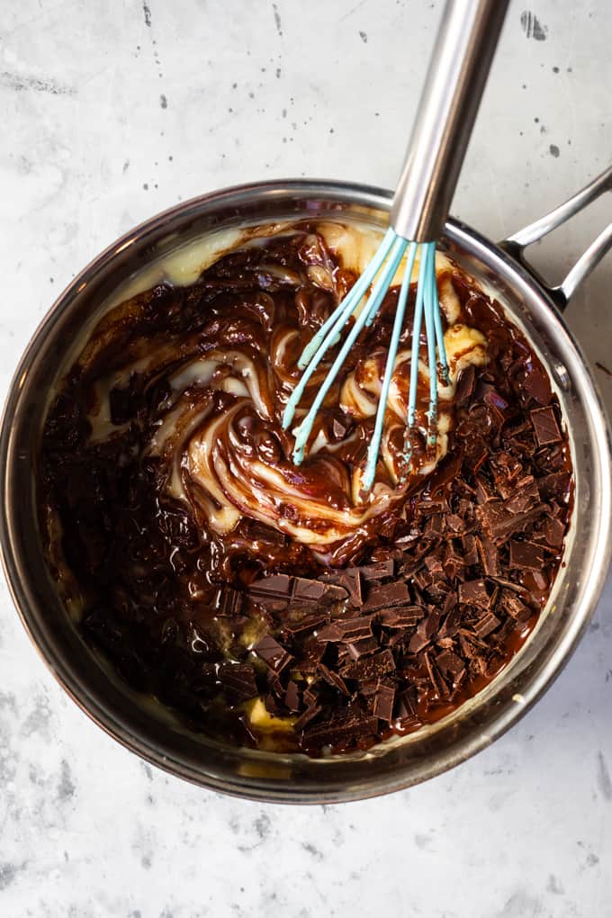 Melting the chocolate pudding in a pot with a whisk. 