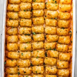 Crispy tater tots lined up on top of a cowboy casserole.