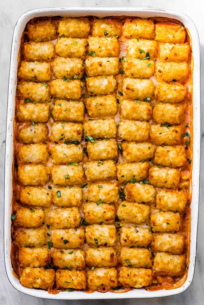 Crispy tater tots lined up on top of a cowboy casserole.