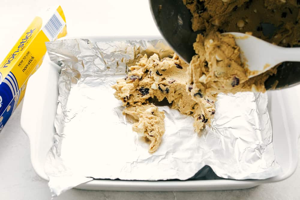 Filling the baking dish with the dough. 