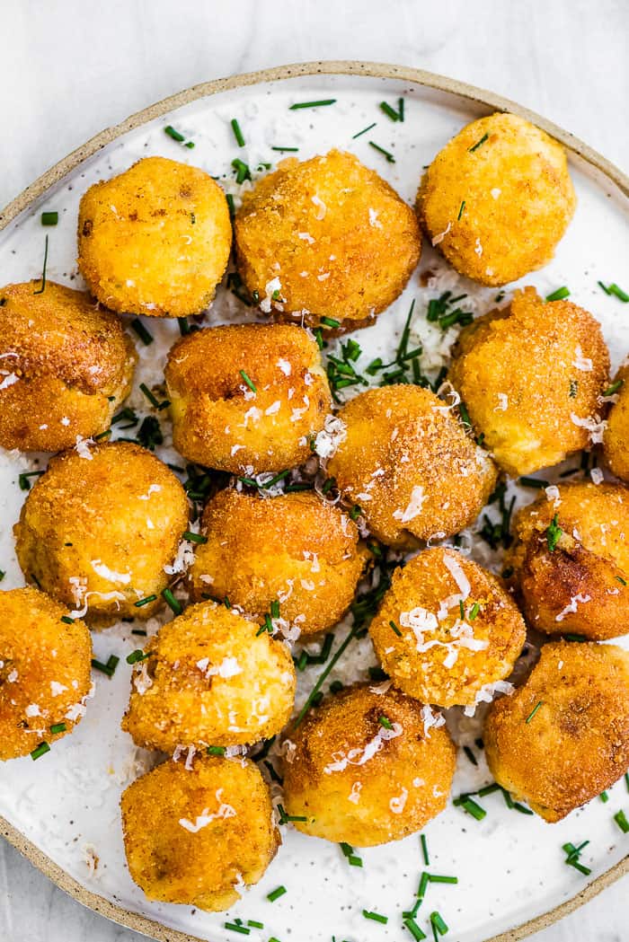 Mashed potato balls on a white plate. 