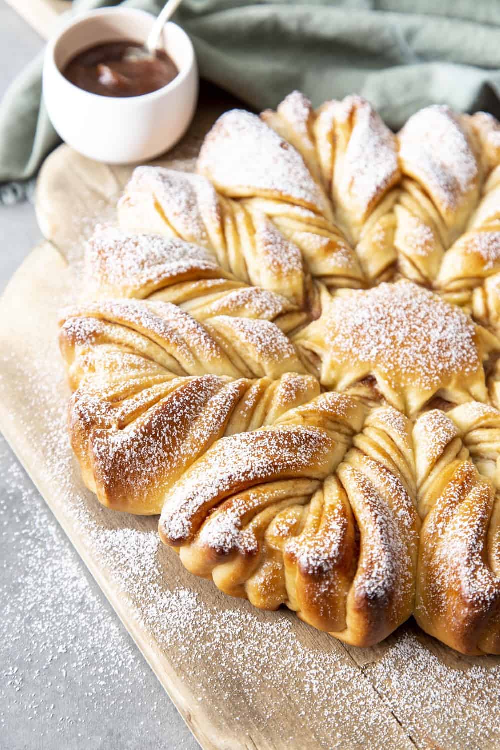 Star bread on serving bread and dusted with powdered sugar.