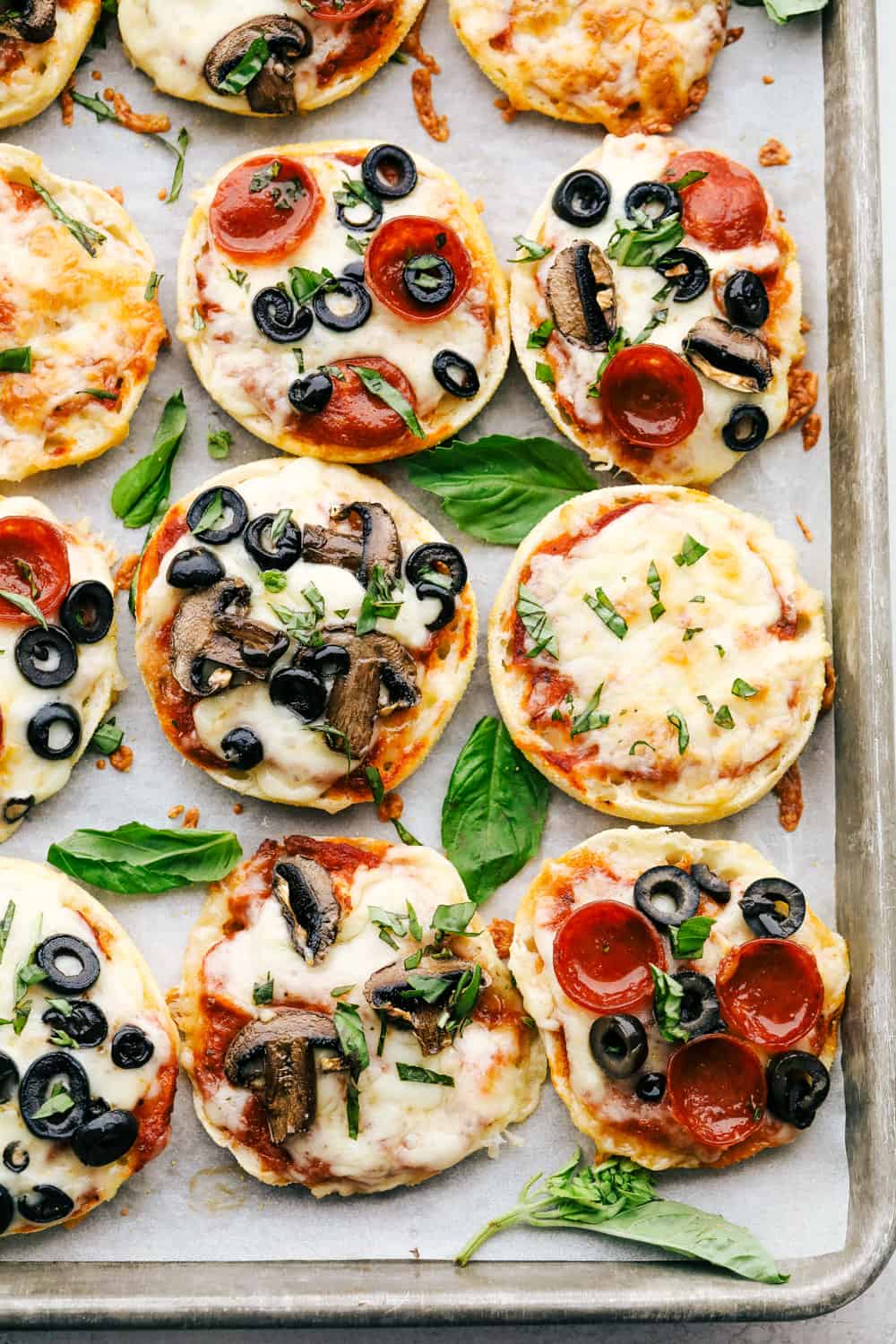 Toasty and perfect english muffin pizzas on a cookie sheet.