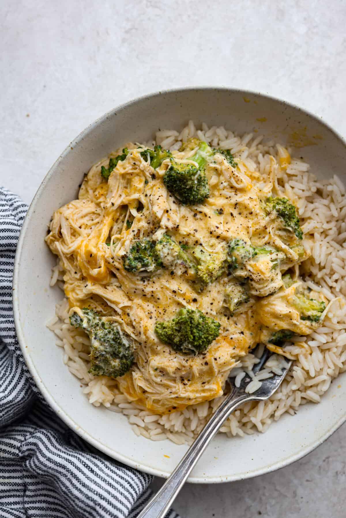 Overhead shot of slow cooker creamy chicken and broccoli over rice plated. 