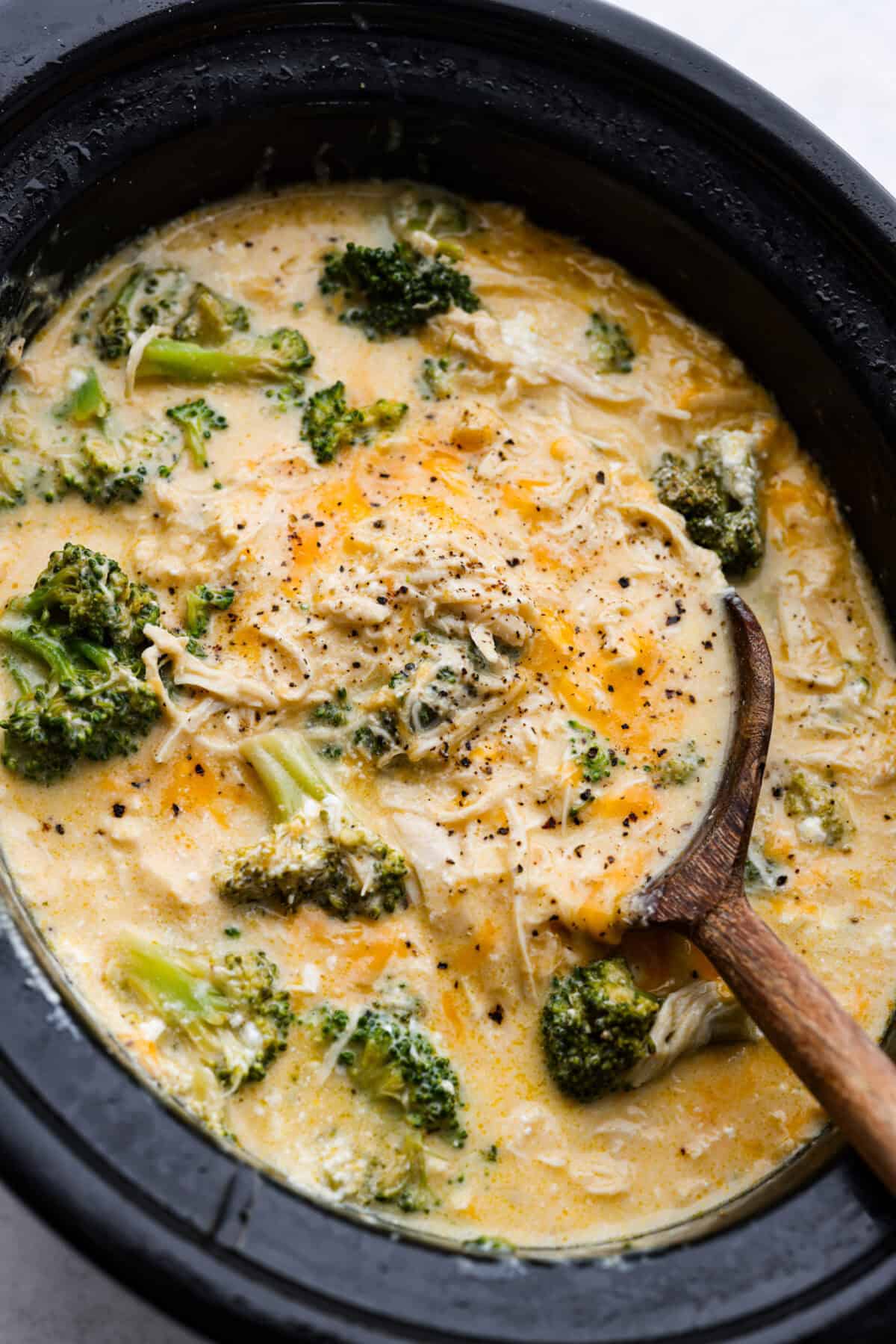 Overhead shot of slow cooker creamy chicken and broccoli in a crockpot. 