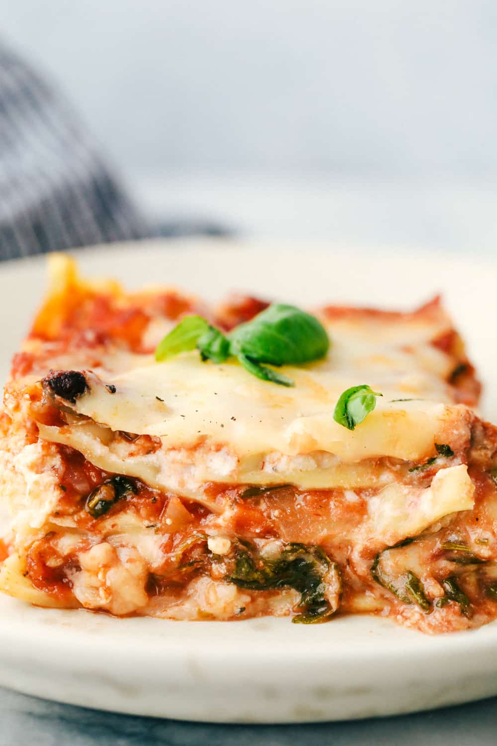 Plated vegetable lasagna with cheese, noodles and sauce. 