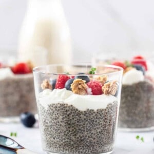 Closeup of a glass filled with chia pudding, yoghurt and berries