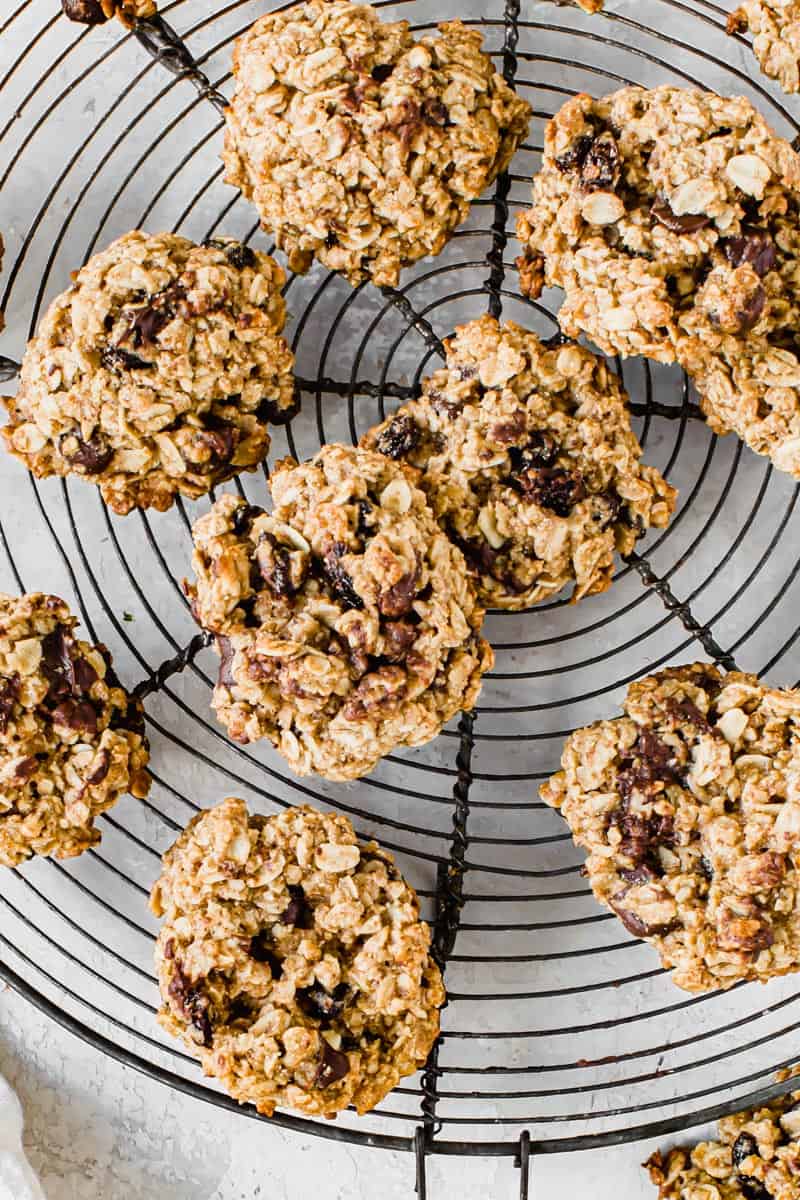 Oatmeal cookies on a round wire rack.