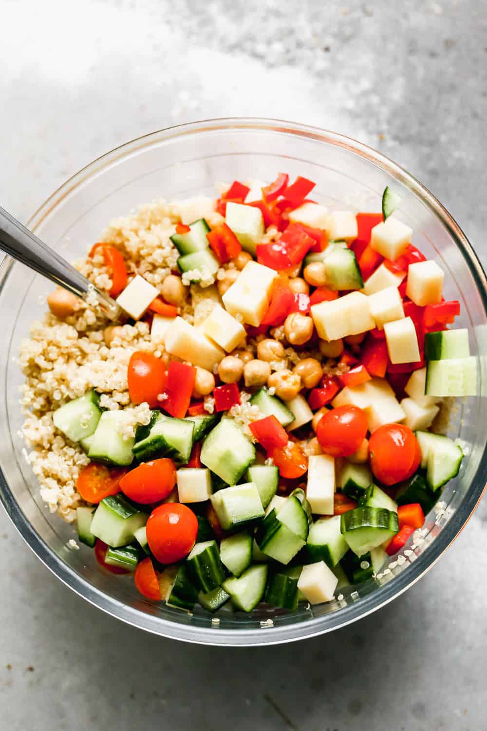 Packed with fuffy quinoa, crisp veggies, chickpeas, salty provolone cheese, and a zesty lemon vinaigrette, this easy Quinoa Salad is the perfect lunch on its own, or base for chicken, salmon or steak for dinner. 30 minutes and done!