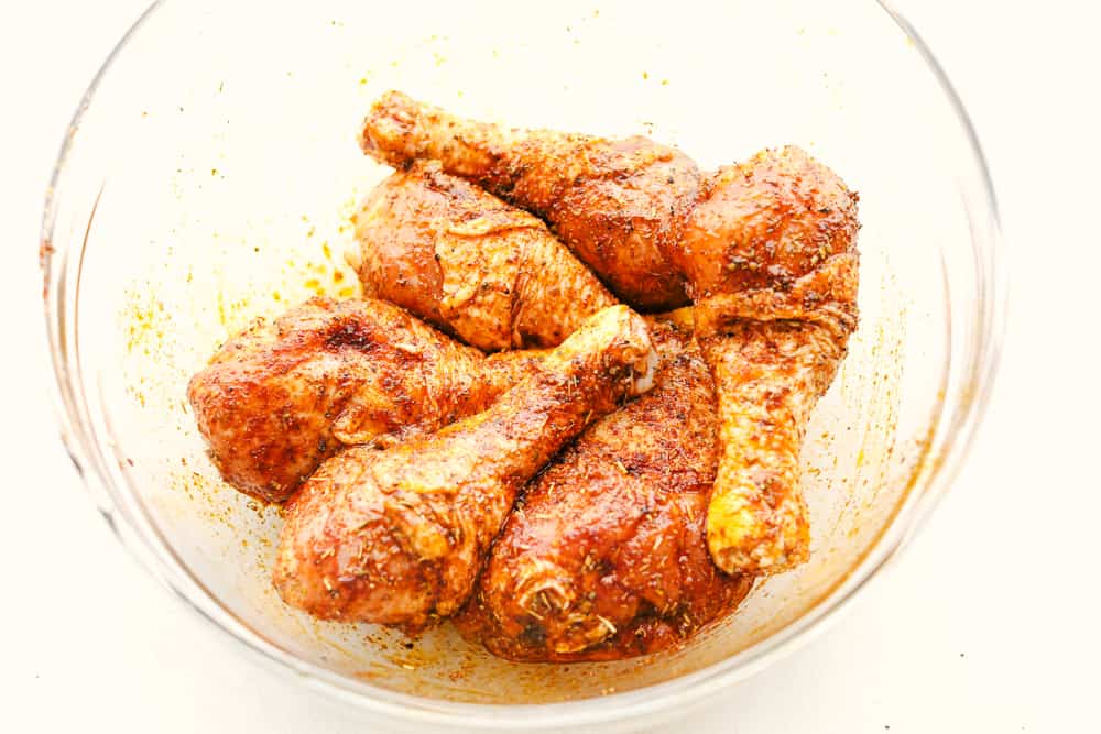 Seasoning chicken legs for the air fryer. 