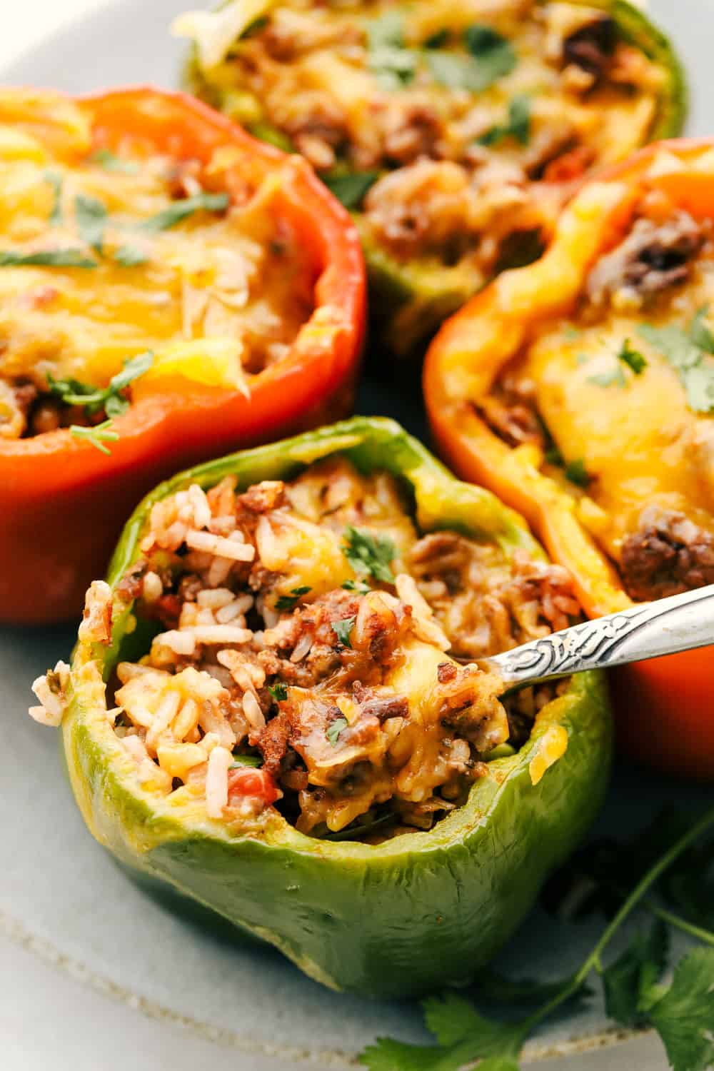 Scooping out the savory filling for stuffed peppers. 