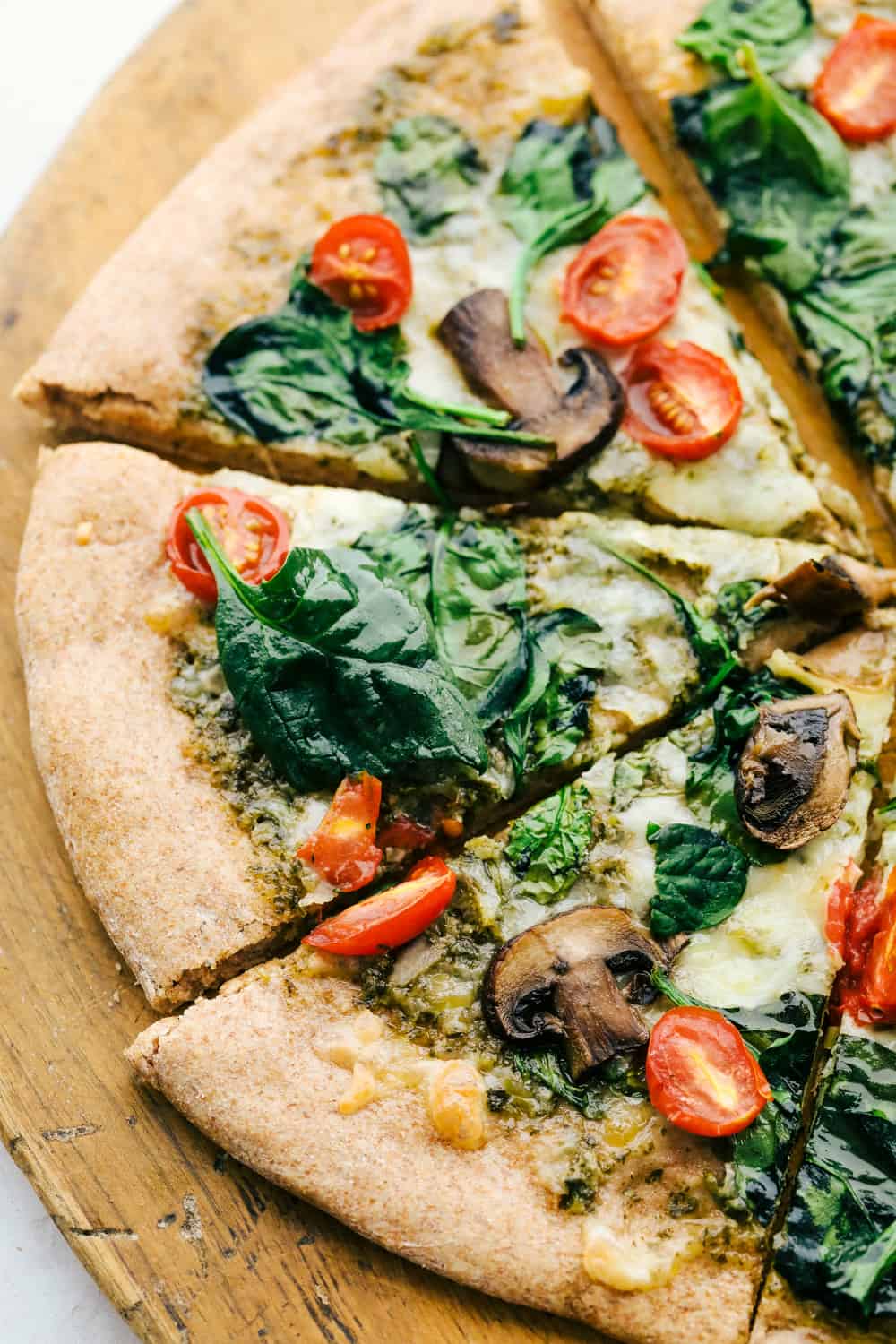 Whole wheat pizza cut into slices, ready to eat. 