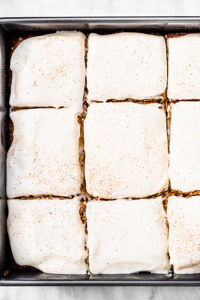 A closeup of carrot cake bars in a pan.