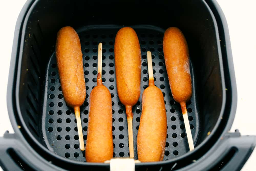 Corn dogs in the air fryer basket. 