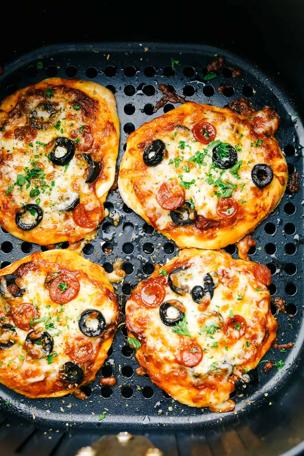 Perfectly baked air fryer biscuit pizzas.