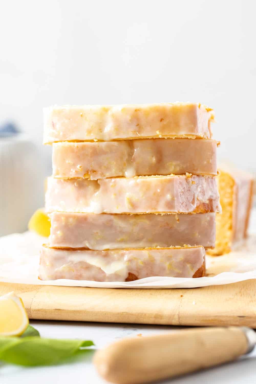 A stack of flat cake slices on a wooden board.