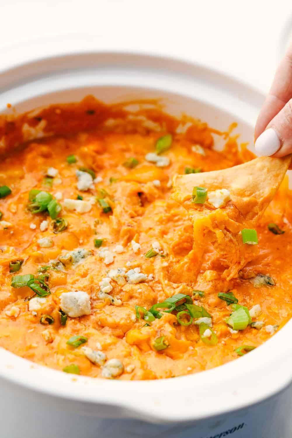 Dipping a chip into Buffalo chicken dip. 