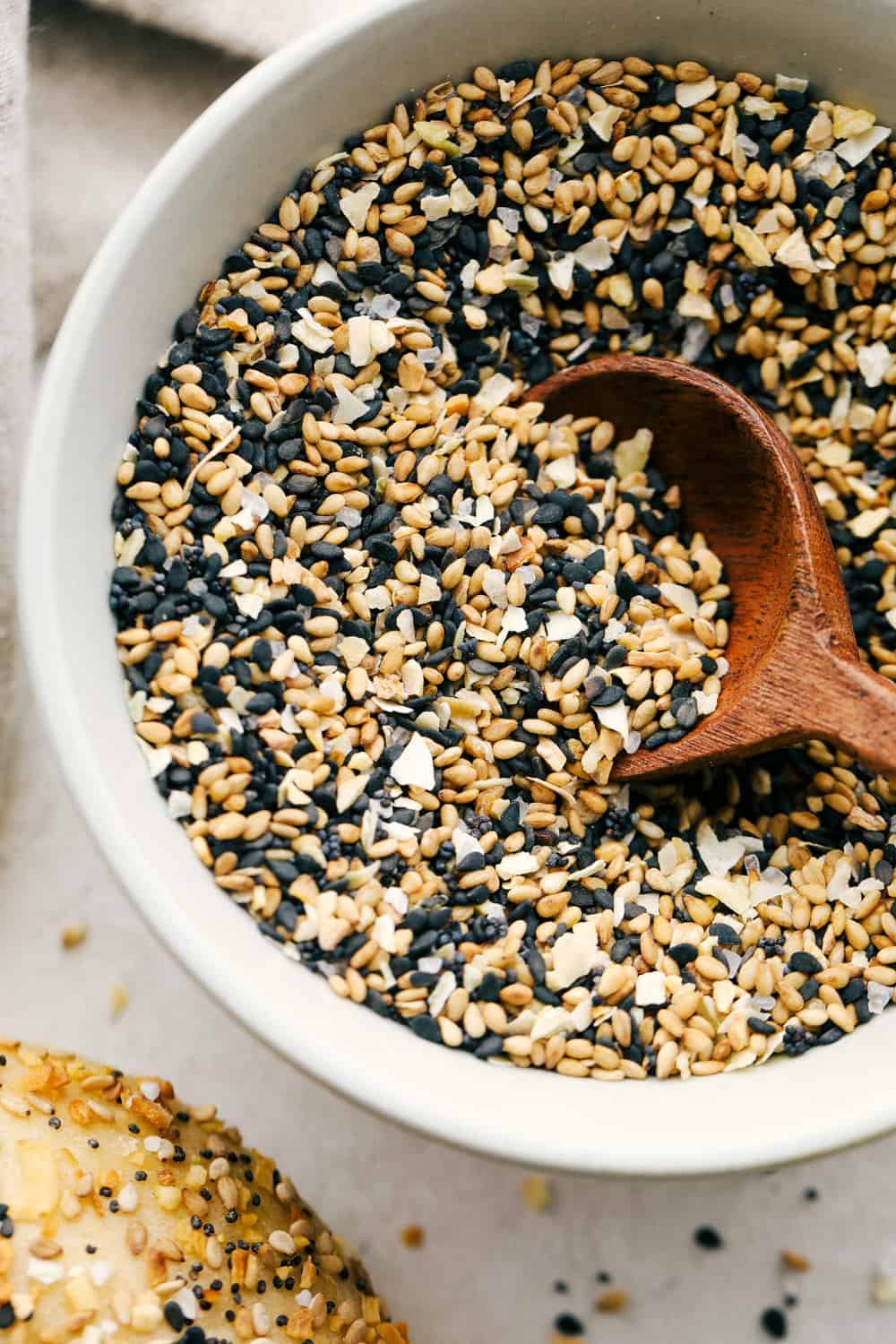 Scooping the seasoning out of a white bowl. 