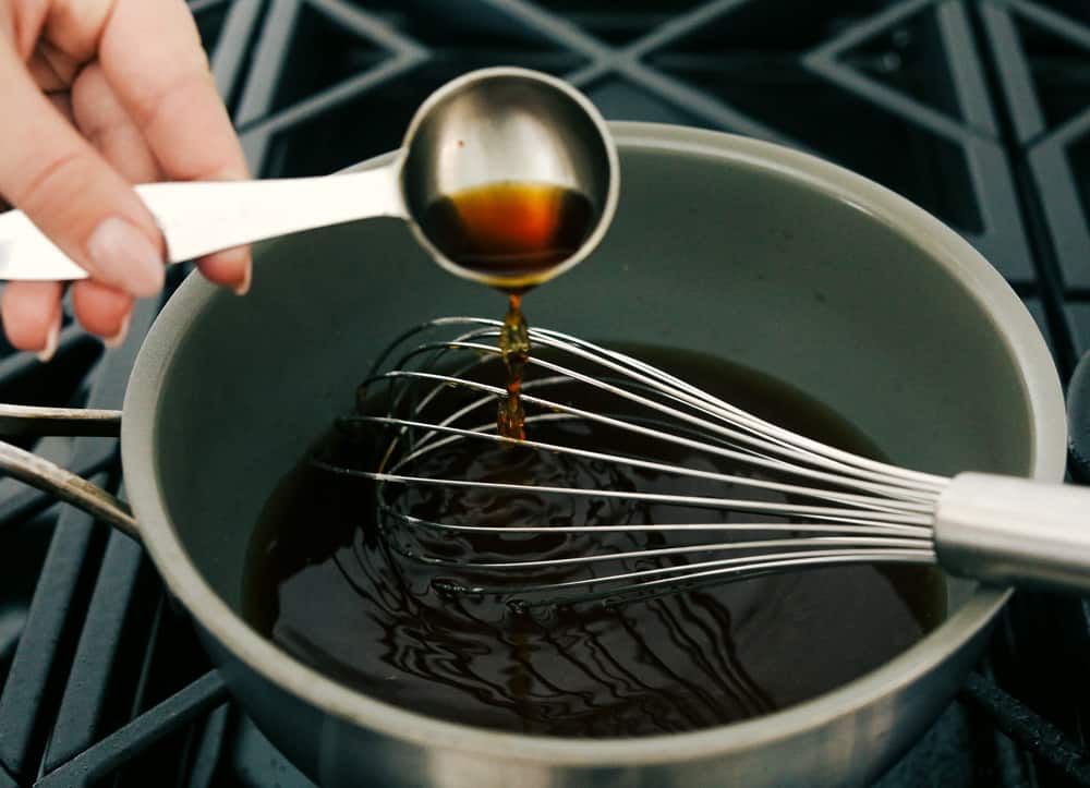 Adding ingredients to a saucepan to make maple syrup. 