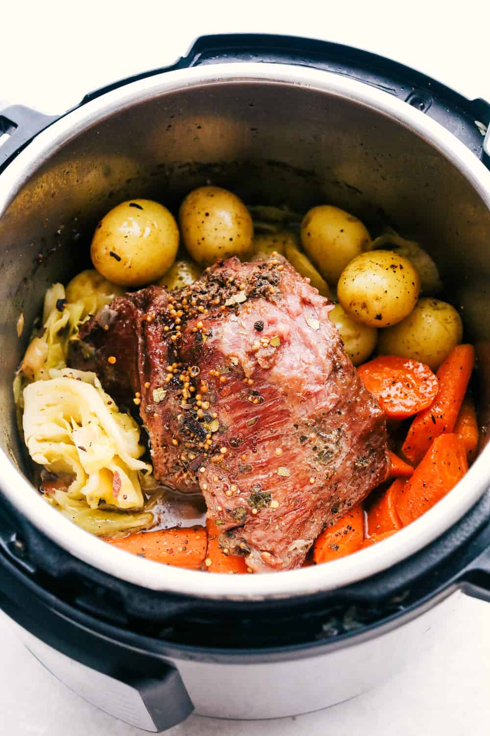 Cooked corned beef with cabbage, potatoes, and carrots. 