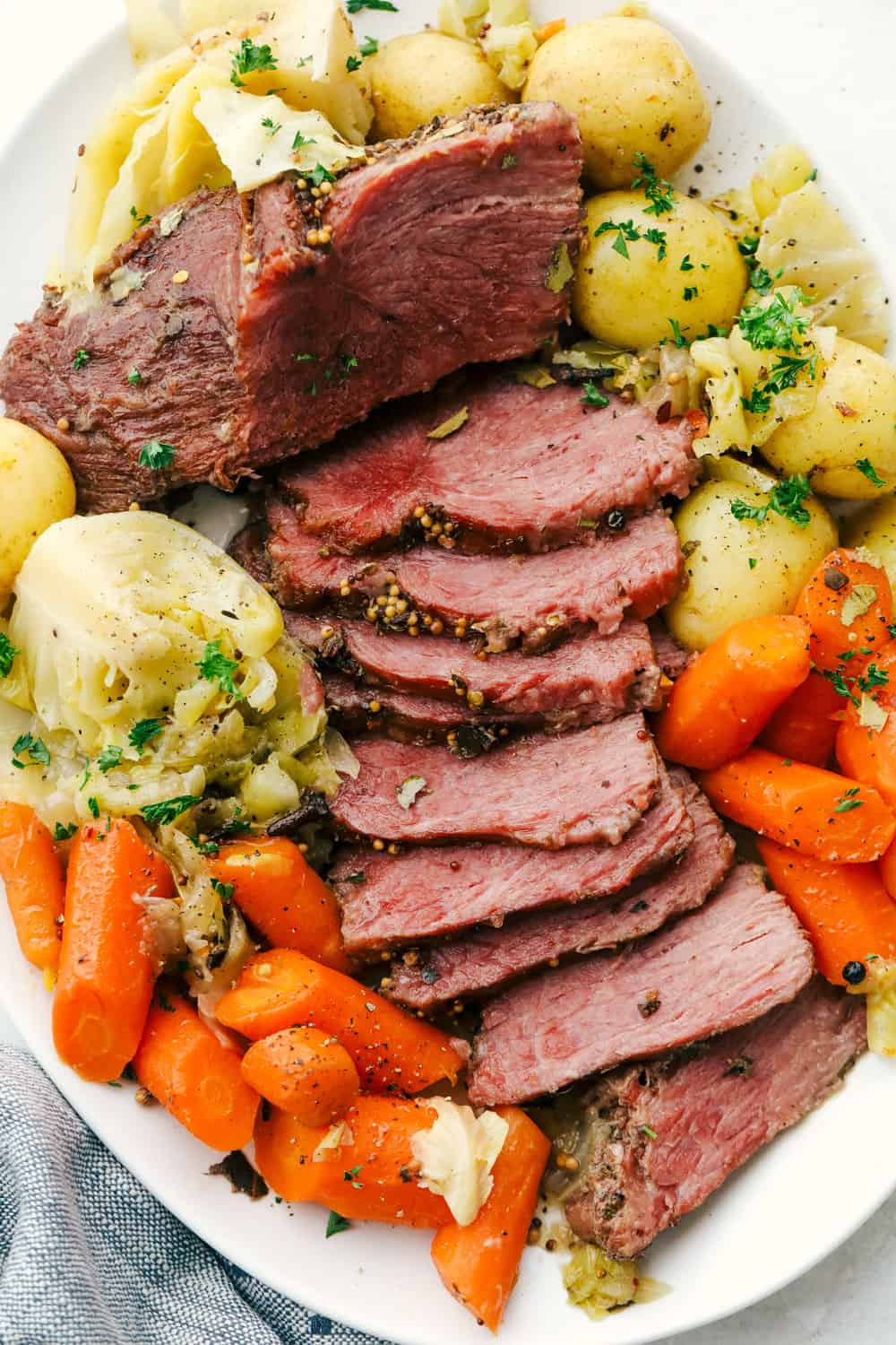 Corned beef, potatoes, cabbages, and carrots on a platter. 