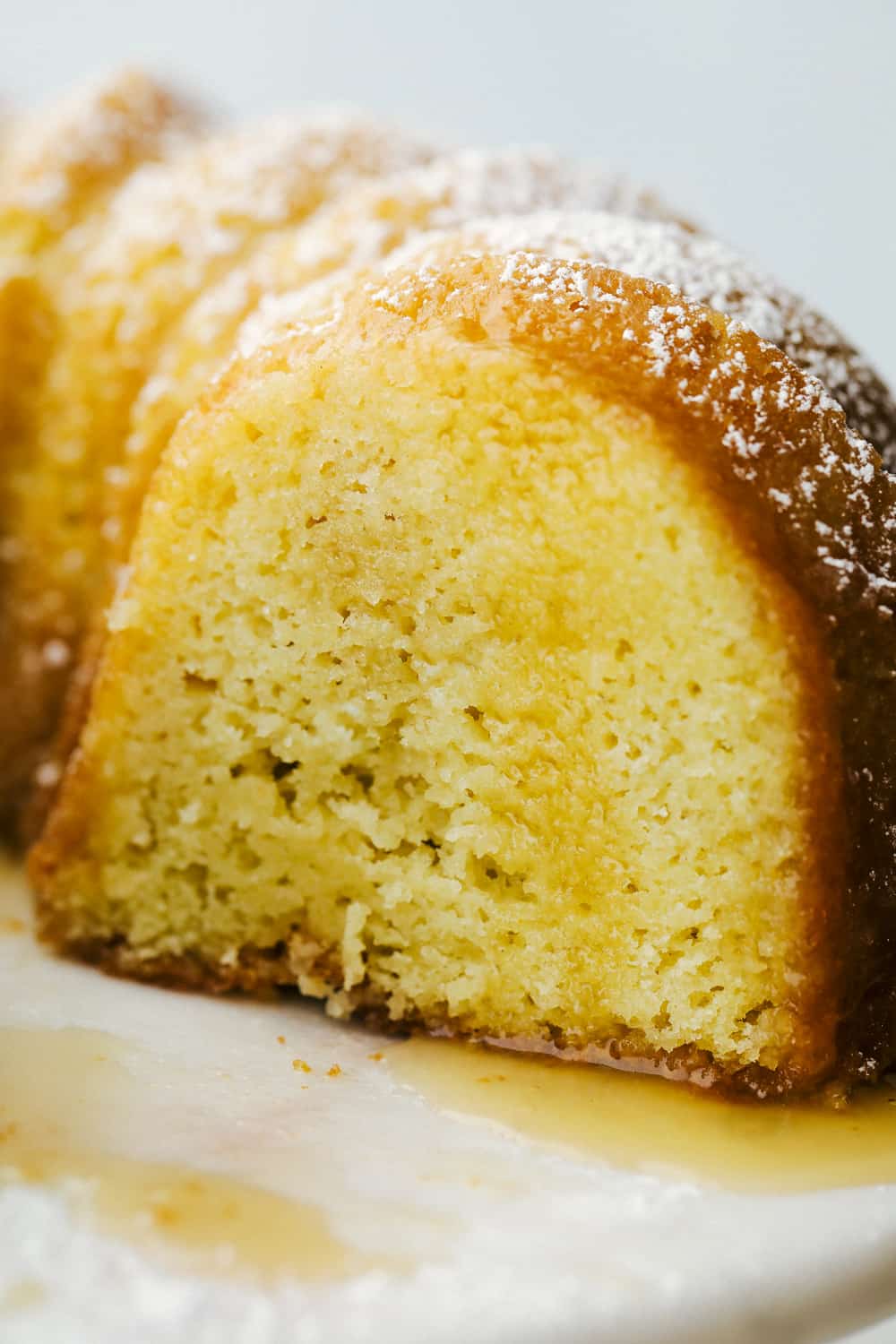 Up close picture of cake with the drizzle soaked into the cake. 