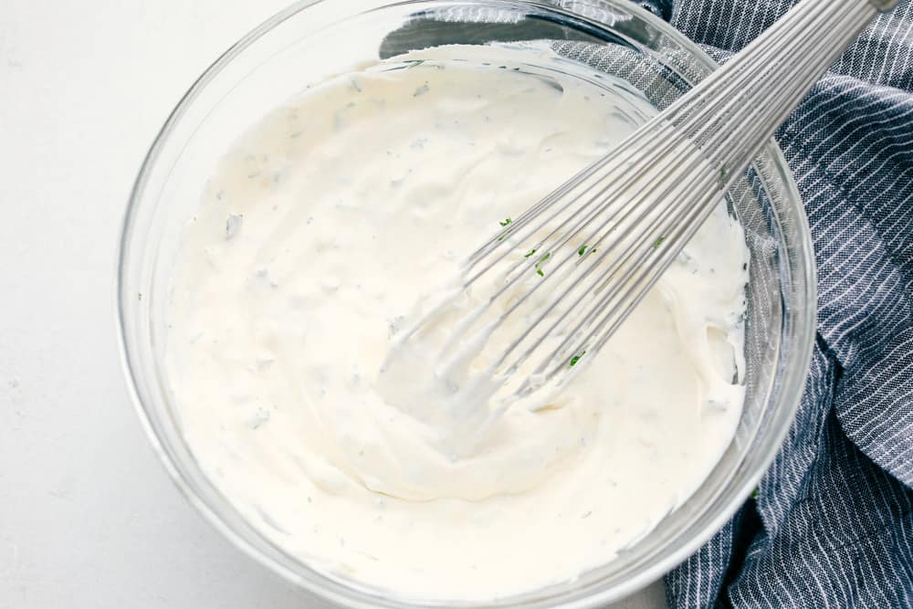 Whisking the ingredients for vegetable dip. 