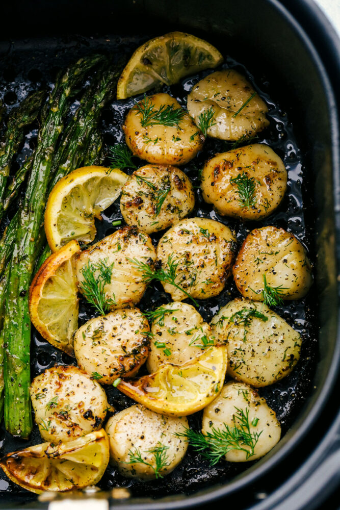 Tender scallops cooked in an air fryer with lemon and dill. 