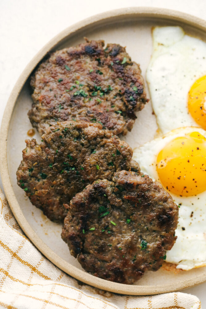 A plate of sausage with eggs on the side. 