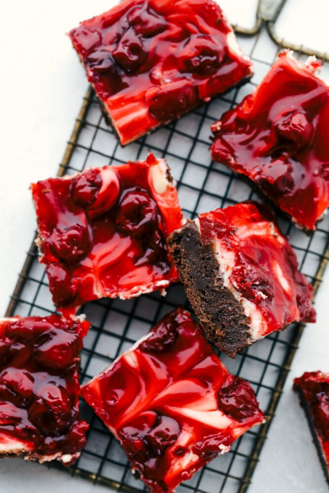 Sliced Cherry cheesecake brownies on  a cooling rack. 