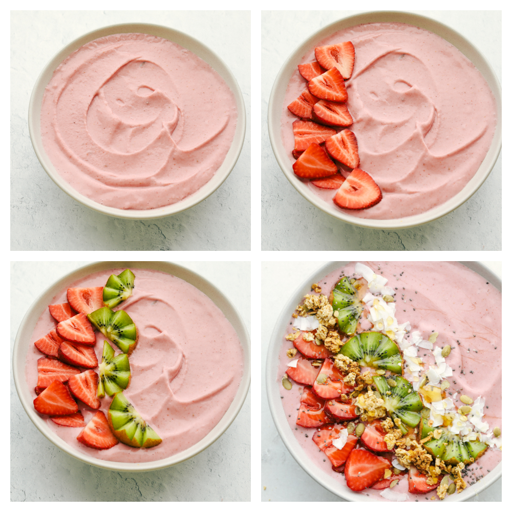 The smoothie in the bowl and being topped with strawberries, kiwii, coconut and granola. 