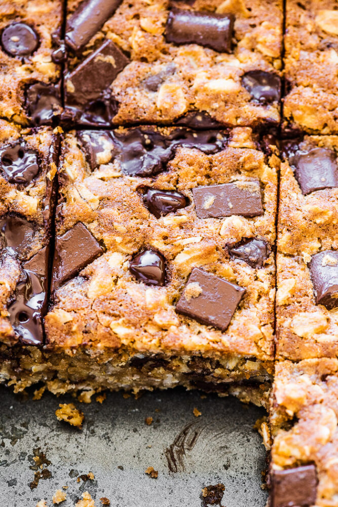 Oatmeal chocolate chip bars in a baking dish with a few missing.