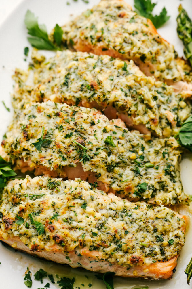 Portioned out salmon with parmesan garlic and butter topping.