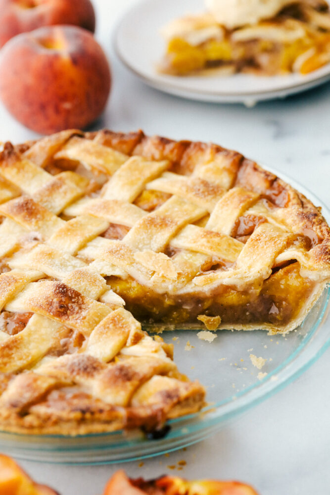 Peach pie with a slice taken out of it. 