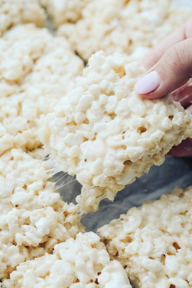 Rice krispie being pulled from pan