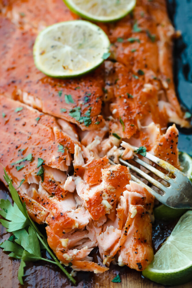 Salmon being cut with a fork.