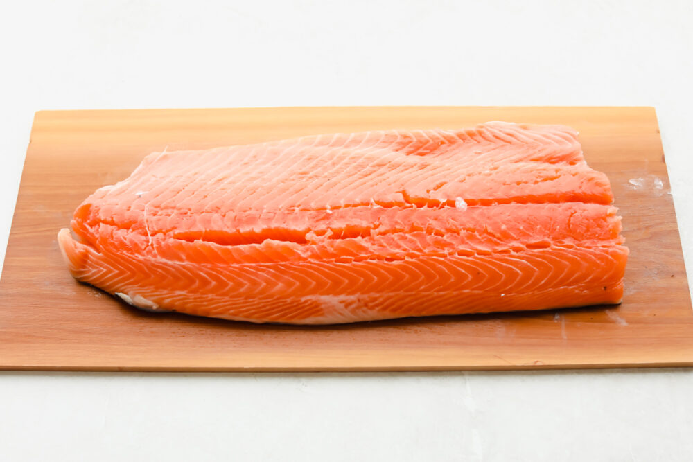 A fresh cut of salmon on cedar plank.