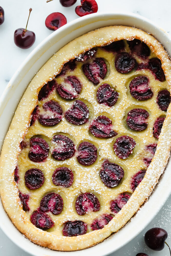 Cherry Clafoutis in a white dish baked and ready to eat. 