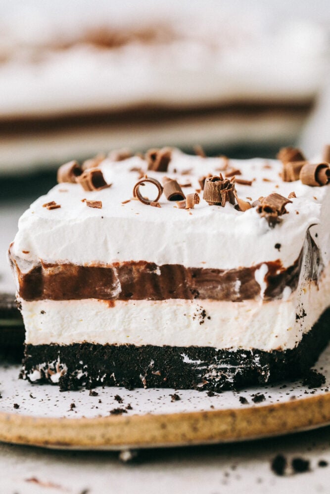 A piece of Oreo Lasagna showing off the layers on a plate. 