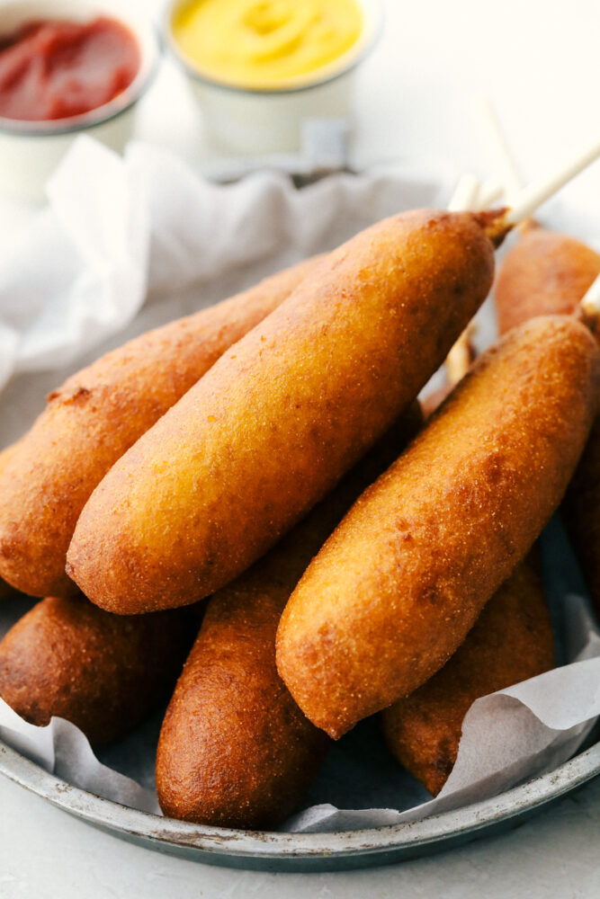 A plate of golden crisp corn dogs. 