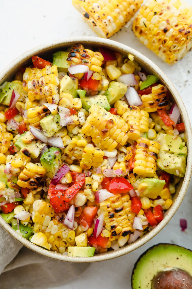 A bowl full of summer corn salad ready to eat. 