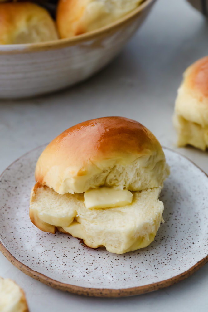 Hawaiian Roll cut in half with dollop of butter.